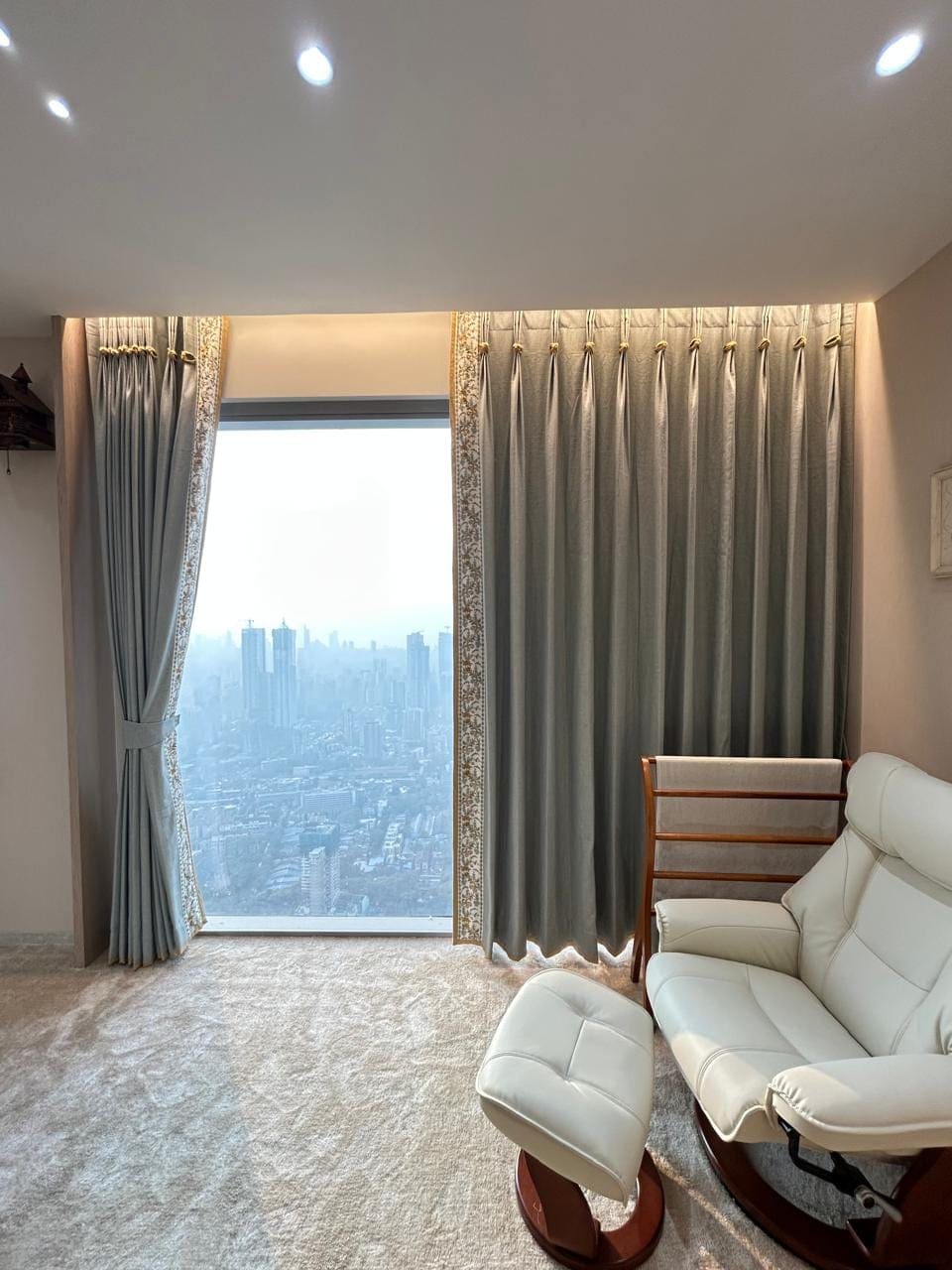 Floor-to-ceiling custom drapes with gold-trim detail, Mumbai high-rise apartment